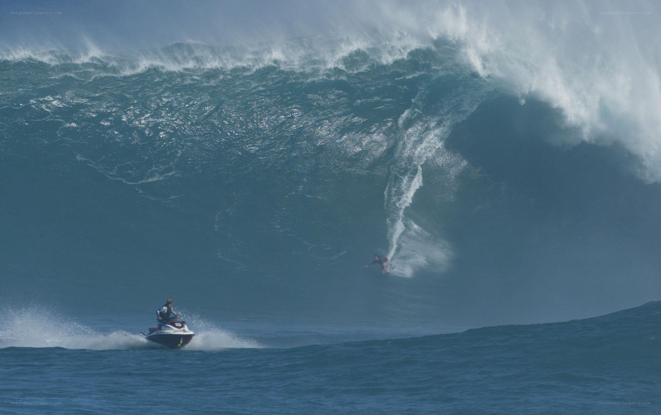 Surfer riding massive wave