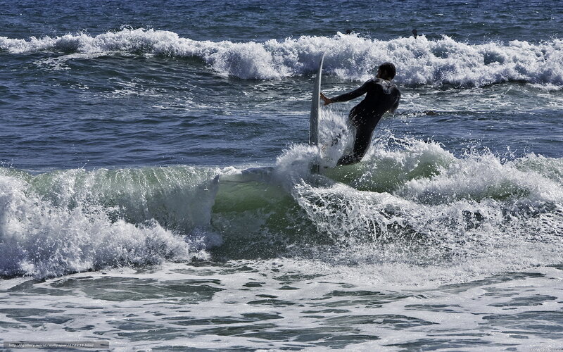 Surfer riding ocean wave