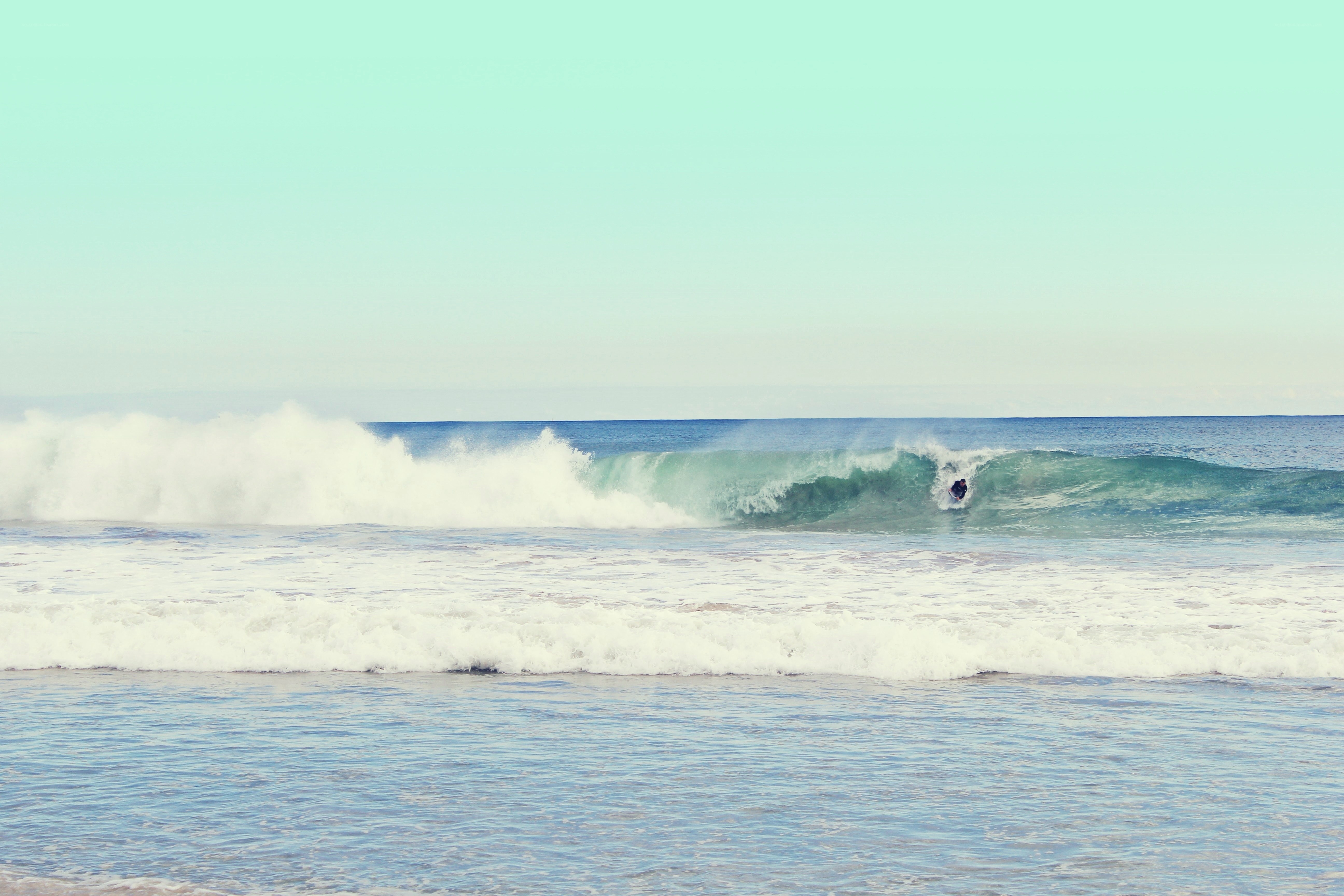 Surfer riding ocean wave