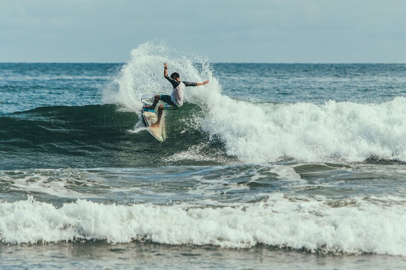 Surfer riding ocean wave