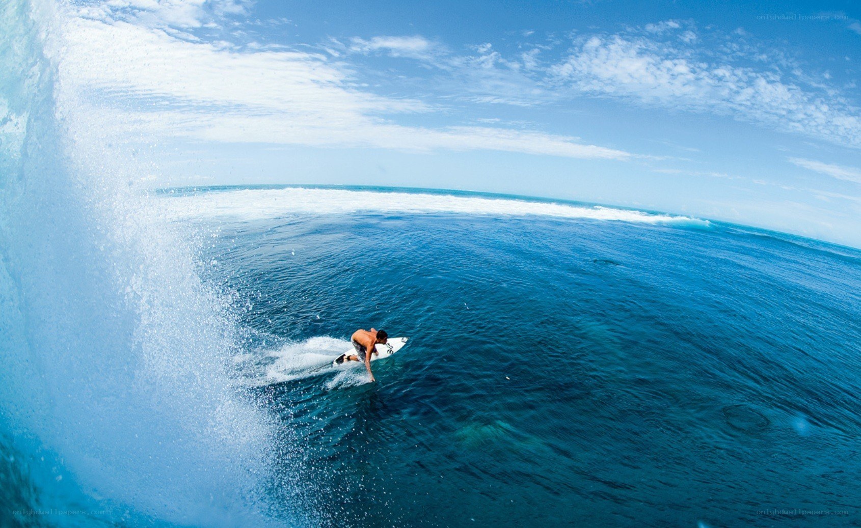 Surfer riding ocean wave