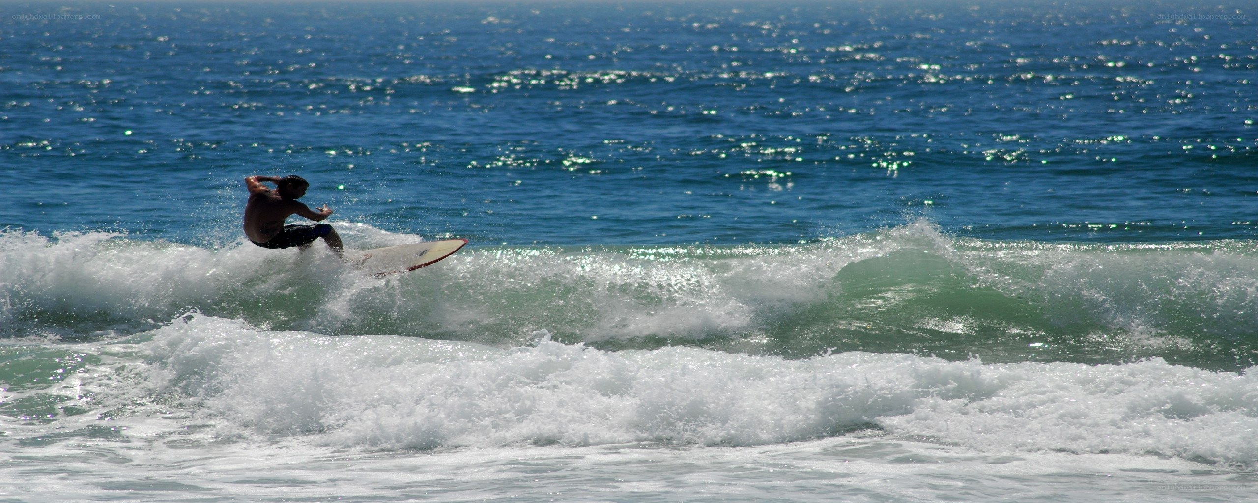 Surfer riding ocean wave