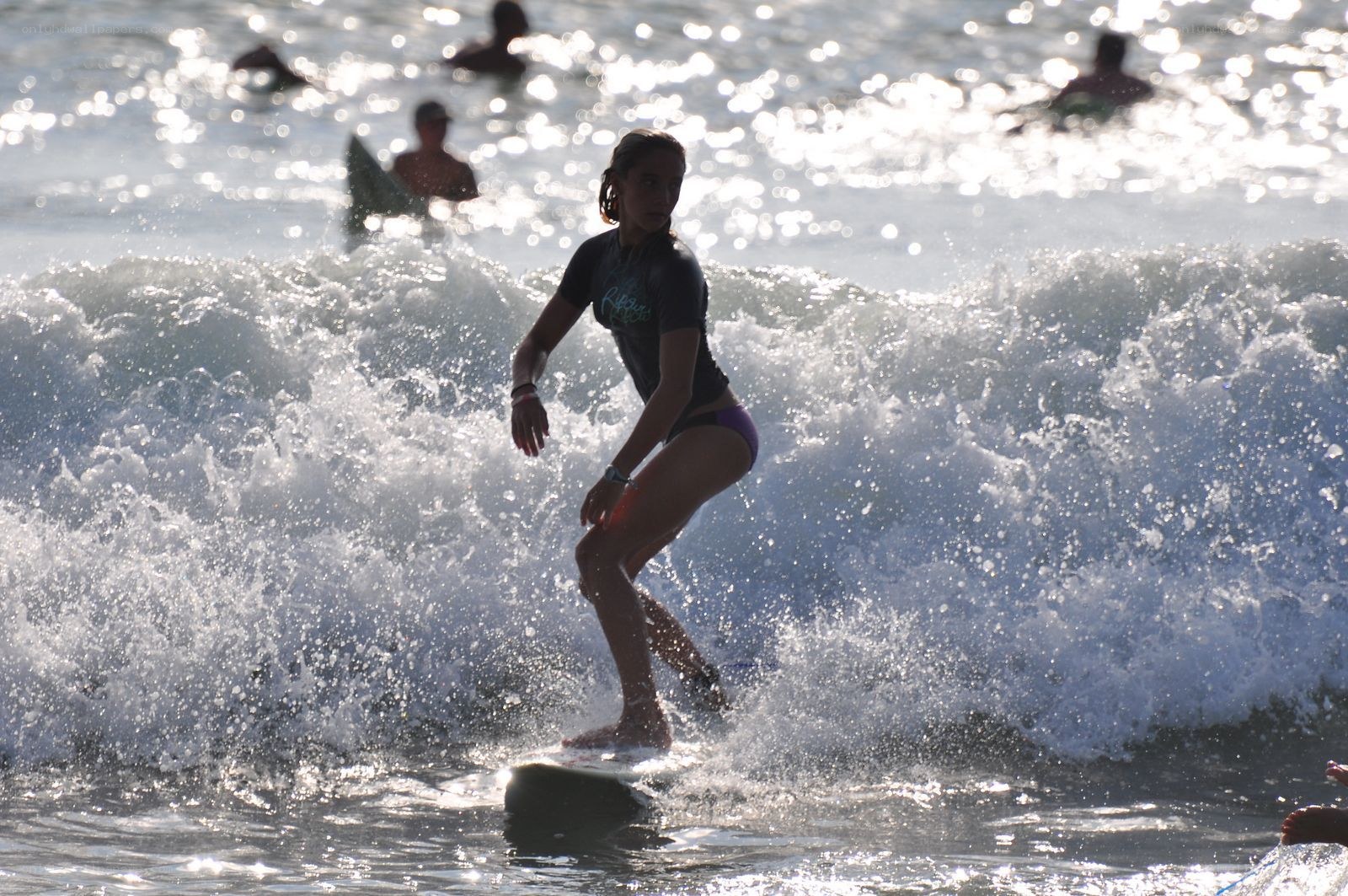 Surfer riding wave at beach