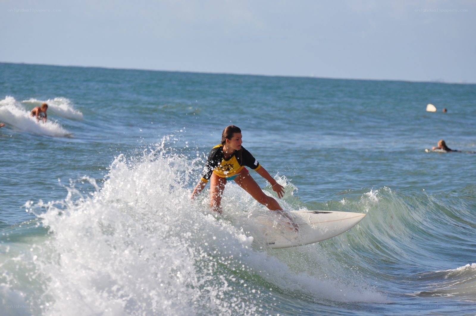 Surfer riding wave at beach