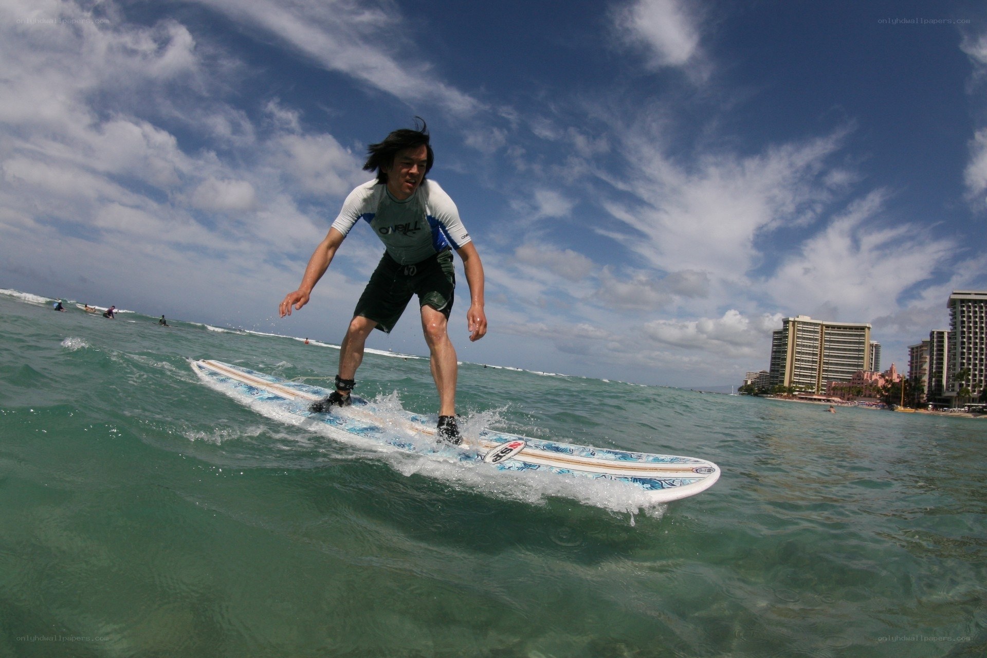 Surfer riding wave at beach
