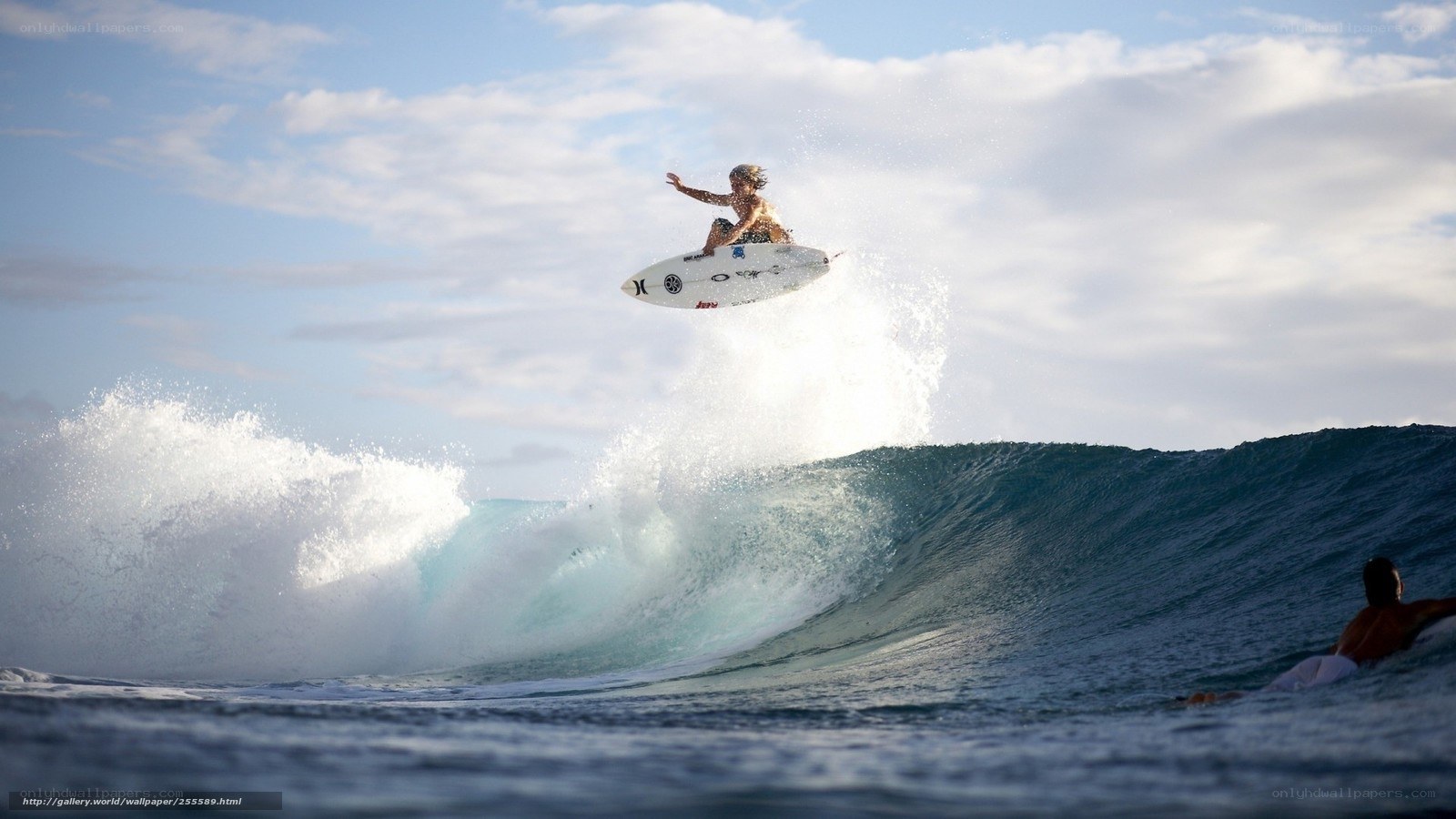 Surfer riding wave in mid-air