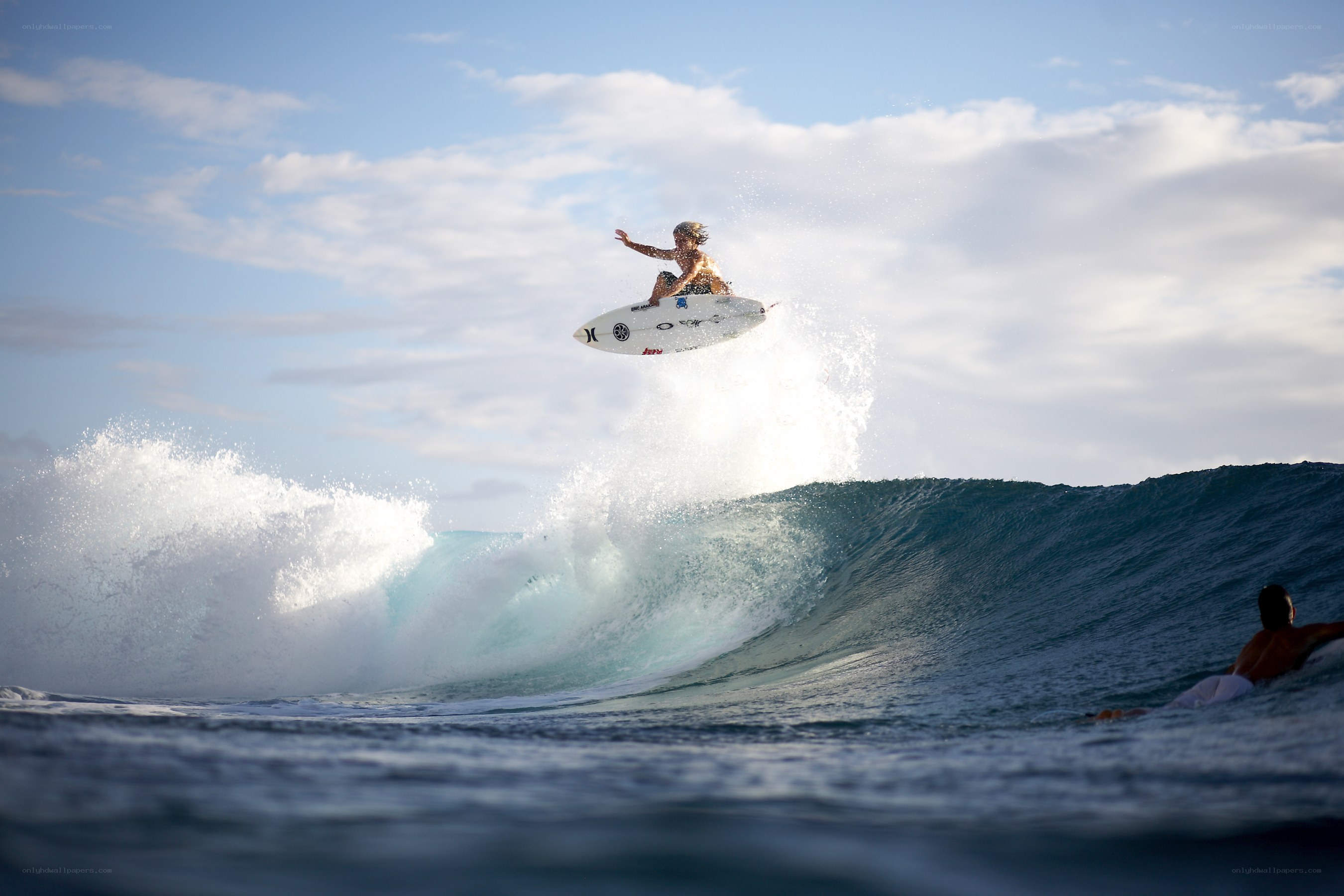 Surfer riding wave in mid-air