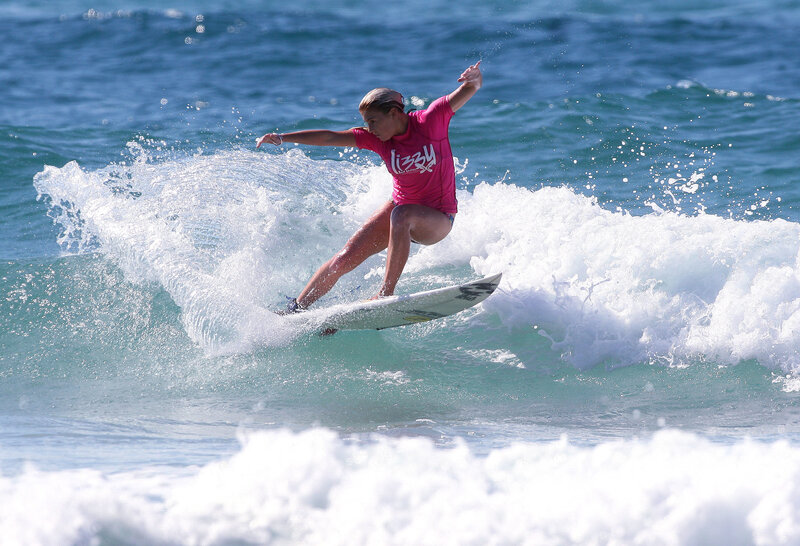 Surfer riding wave in pink shirt