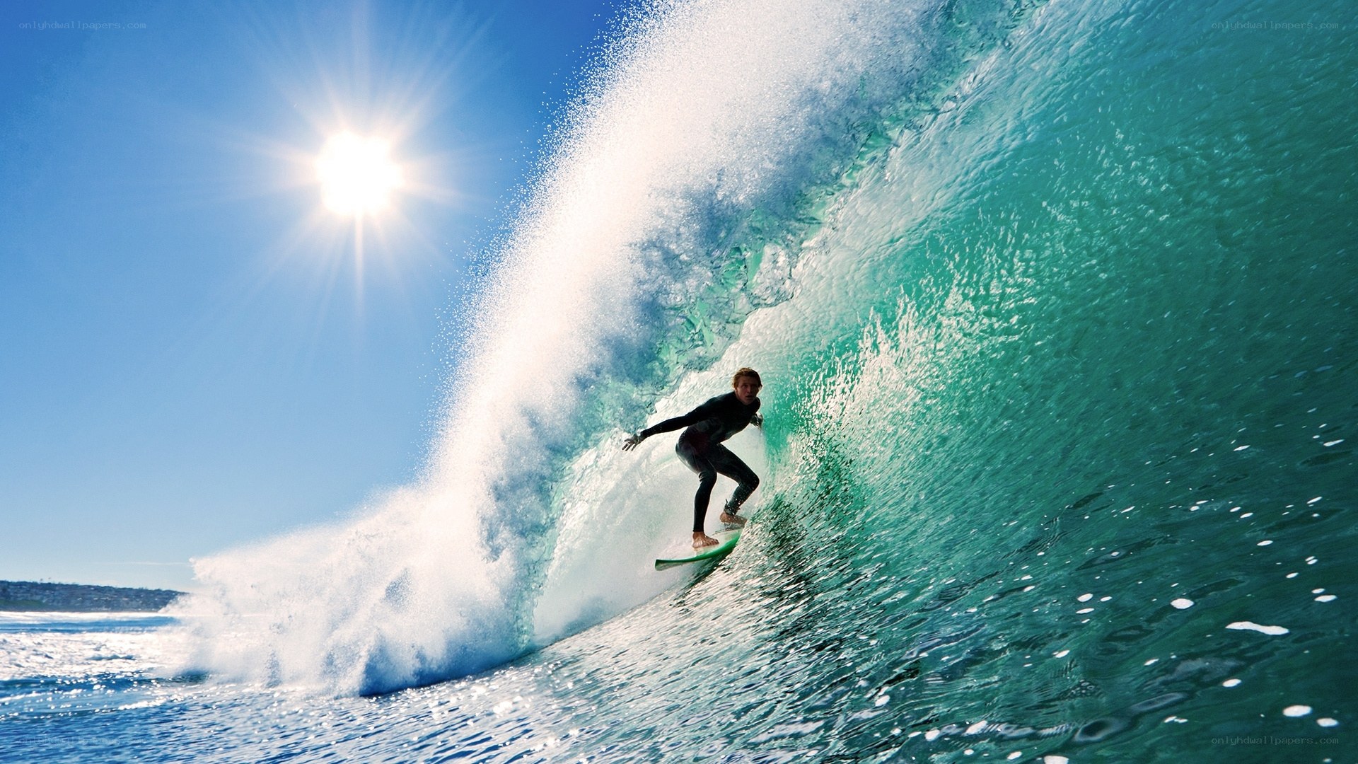 Surfer riding wave in sunlight