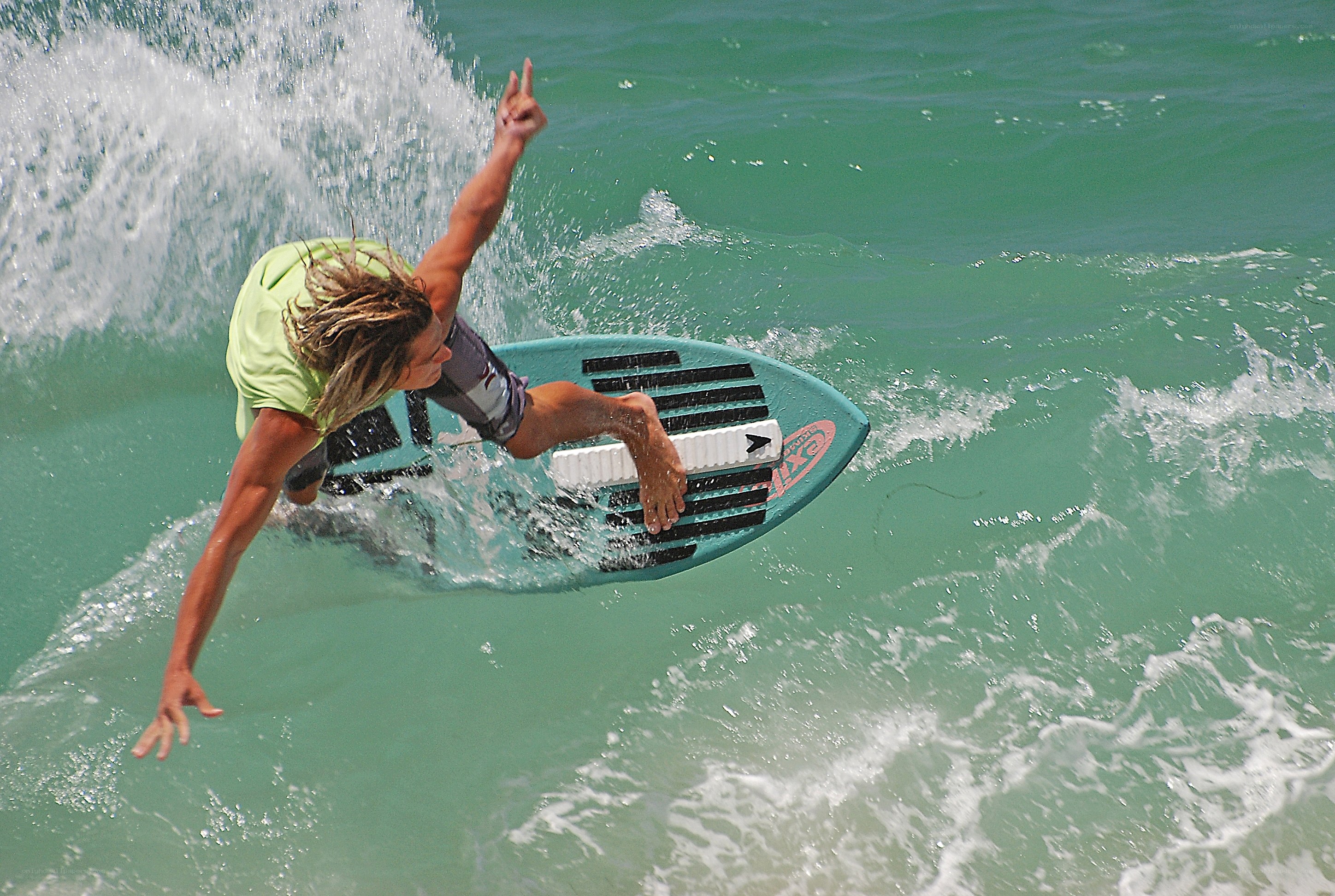Surfer riding wave on board