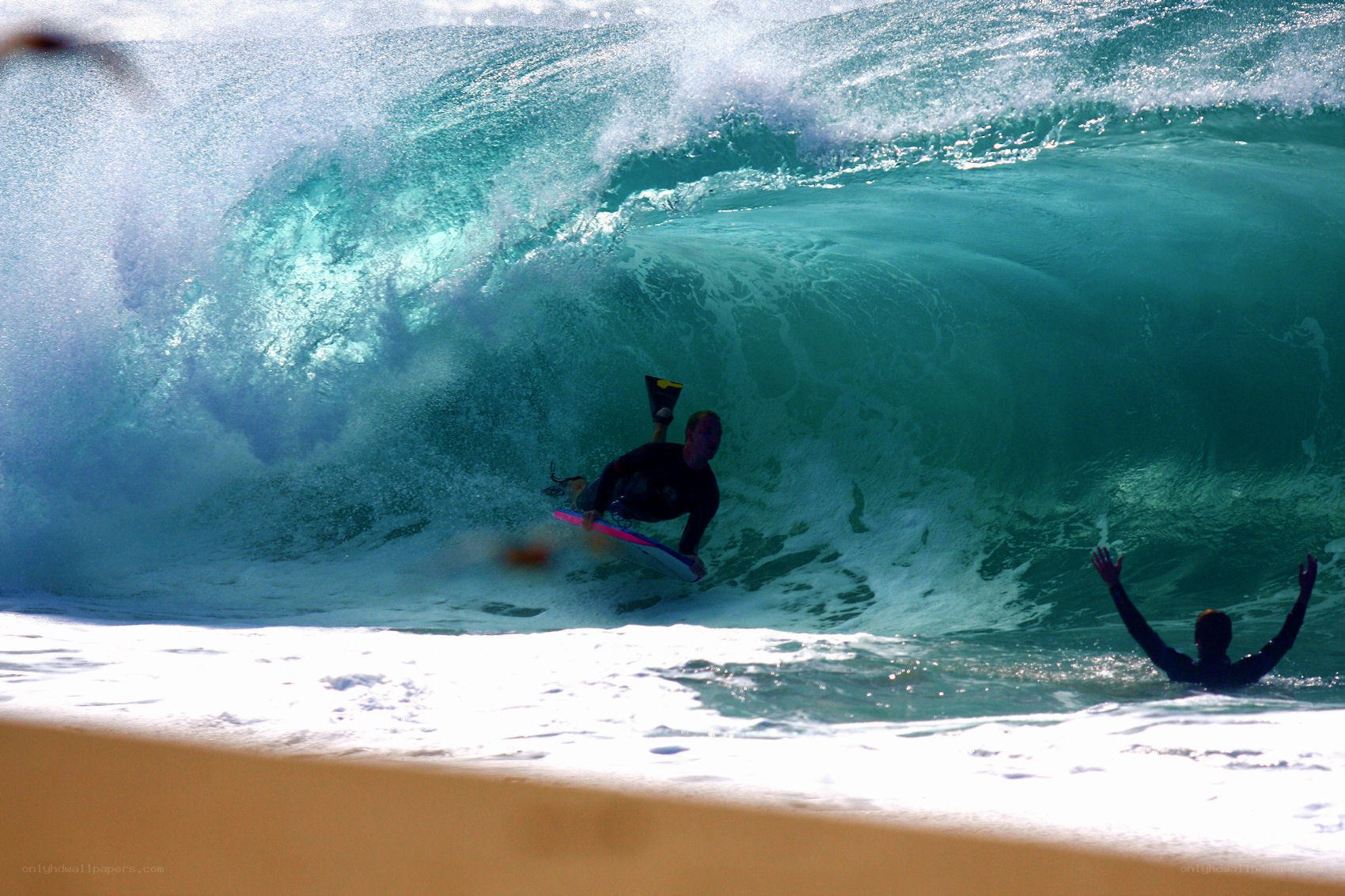 Surfer riding wave on bodyboard