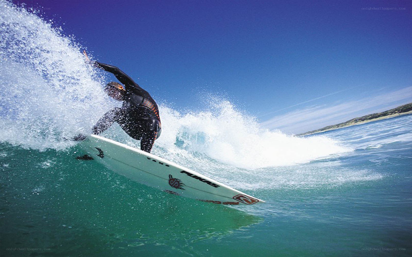 Surfer riding wave on surfboard