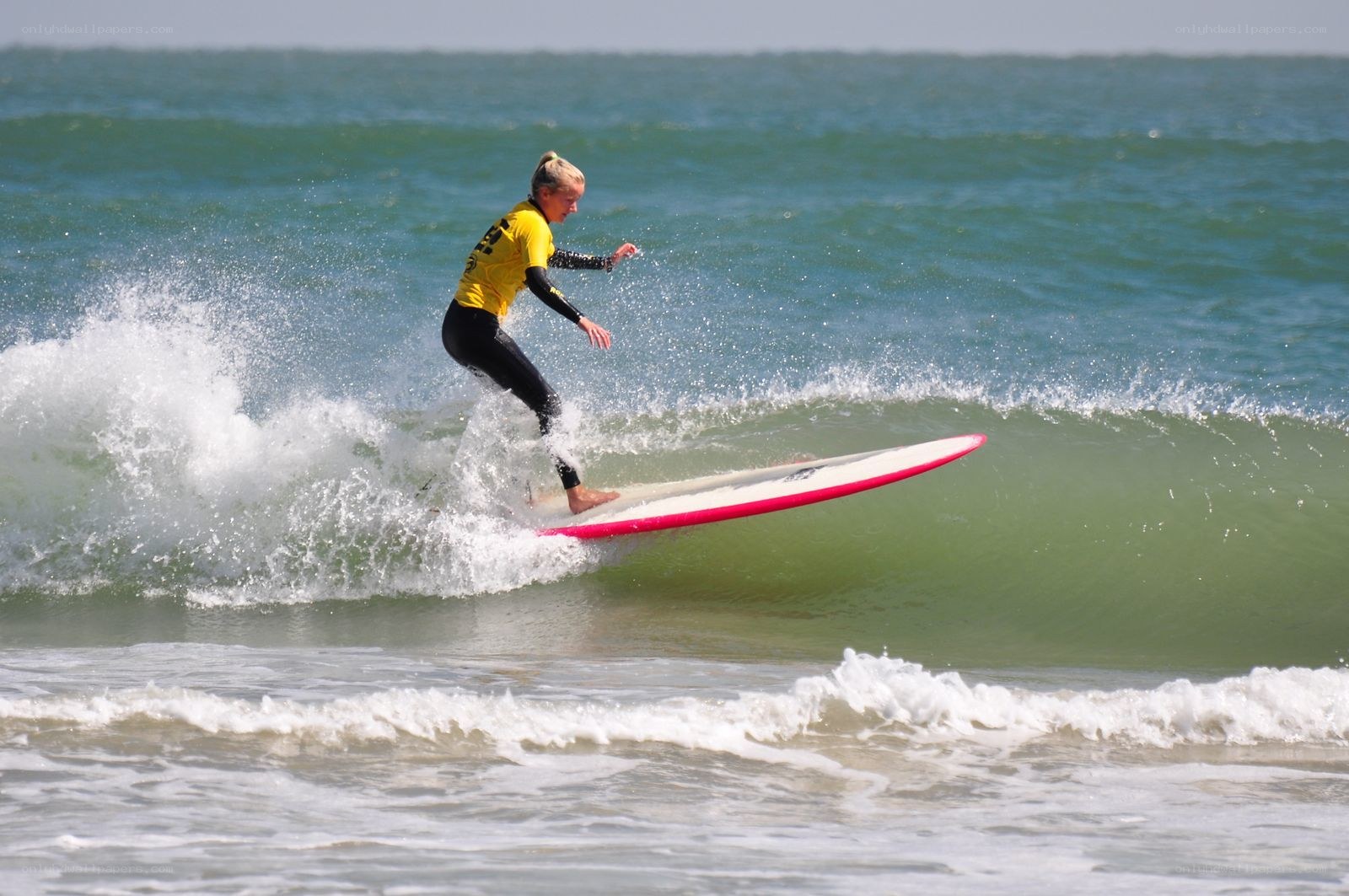 Surfer riding wave on surfboard