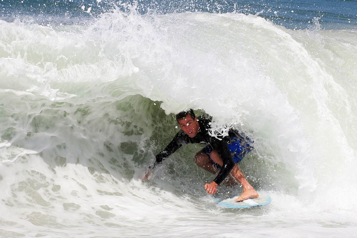 surfer riding wave tunnel
