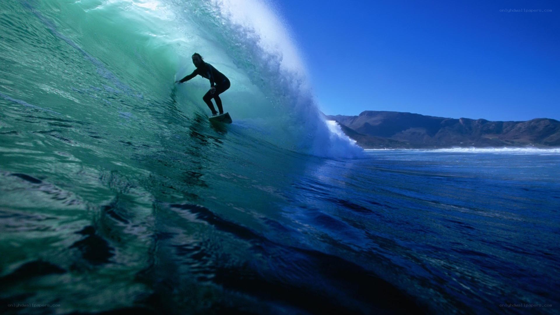 surfer riding wave tunnel