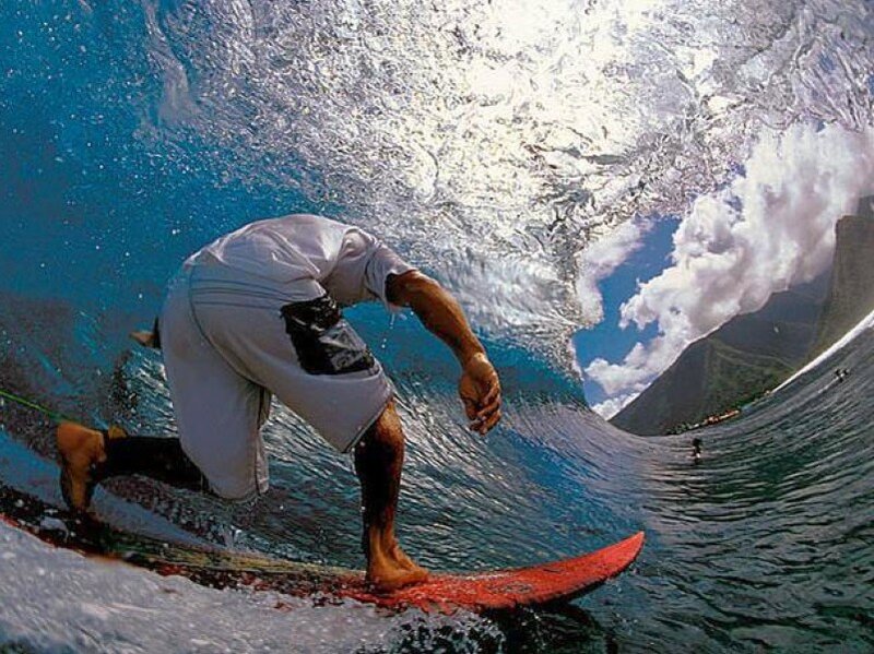 surfer riding wave underwater