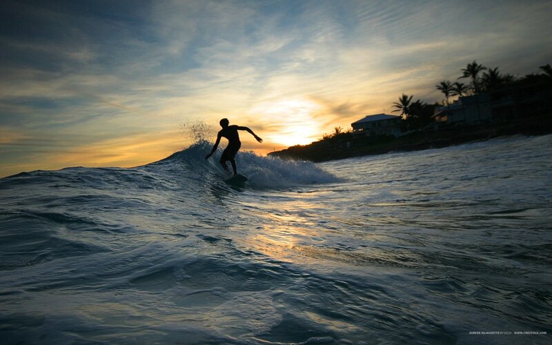 Surfer silhouette at sunset