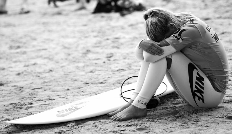 Surfer Sitting on Beach — Black, Somber