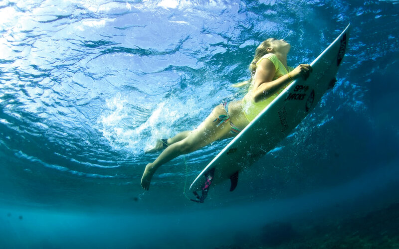 Surfer swimming underwater