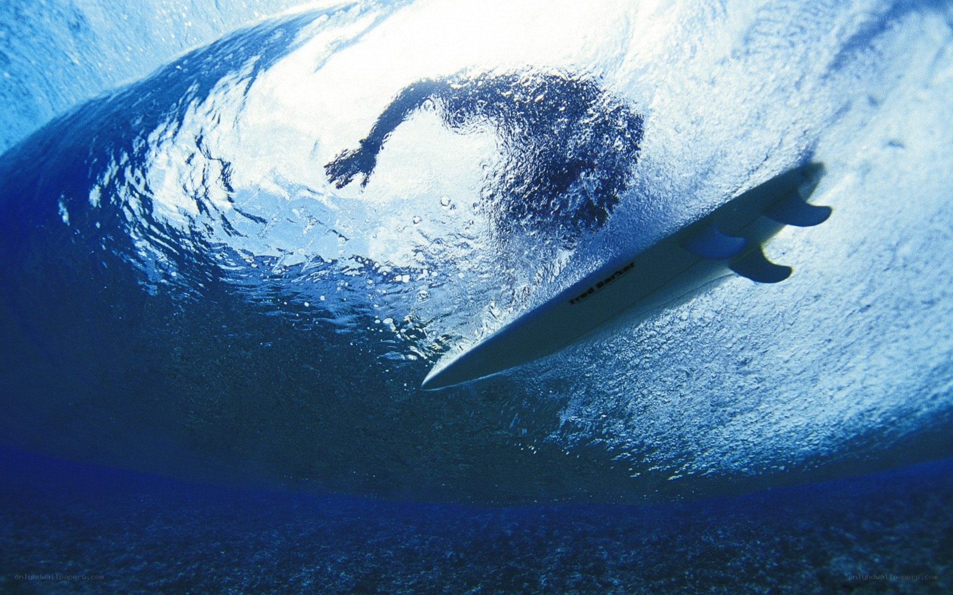 Surfer under a wave