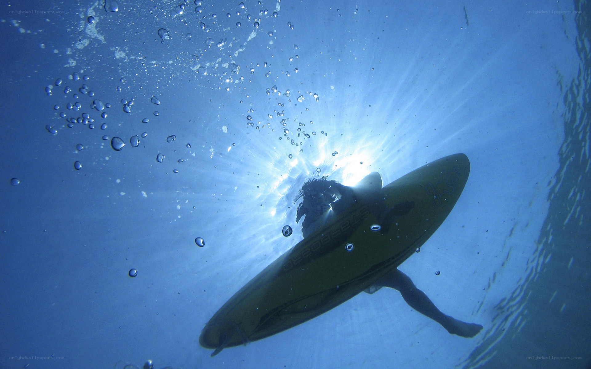 Surfer underwater with board