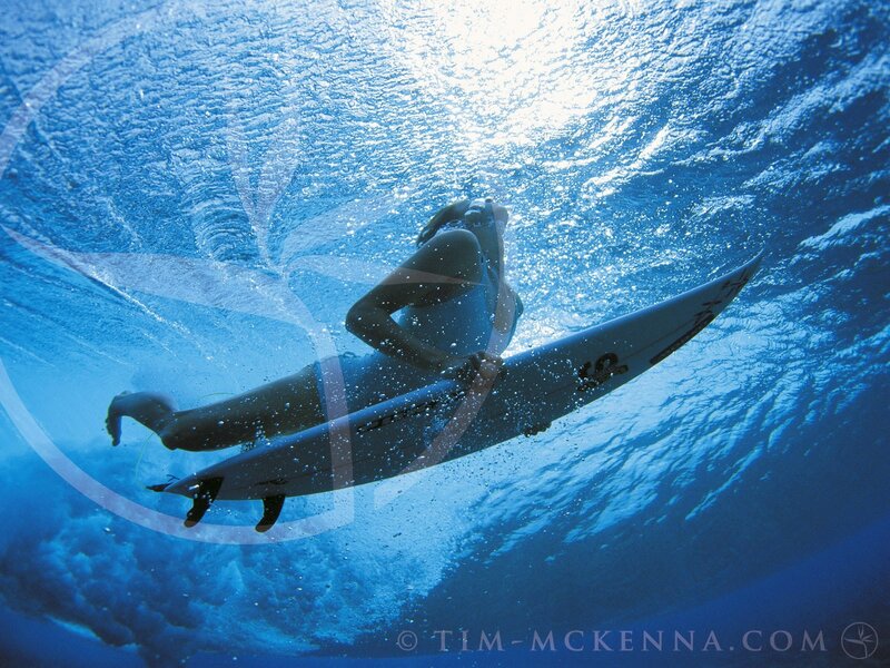 Surfer underwater with board