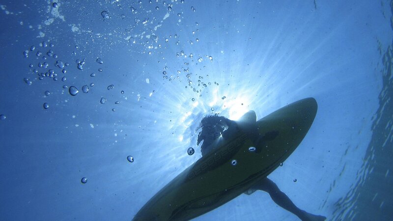 surfer underwater with board