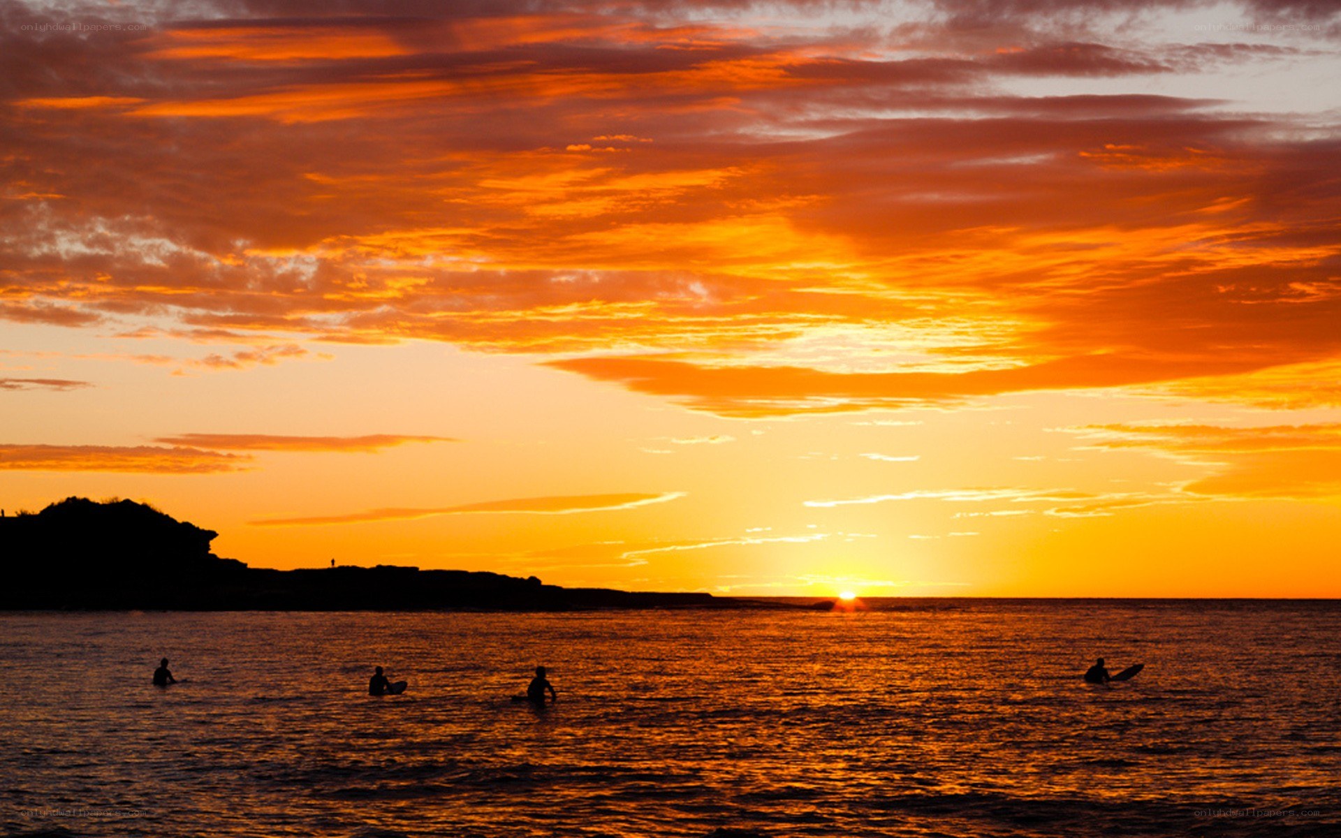 Surfers at sunset