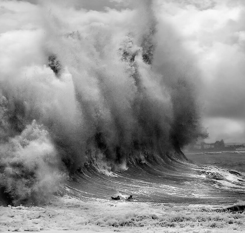 Surfers facing massive wave