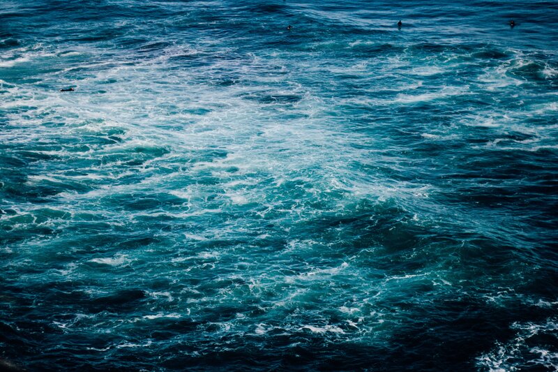 Surfers in Turbulent Water
