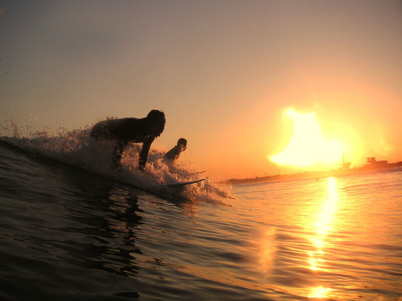 Surfers on a Wave