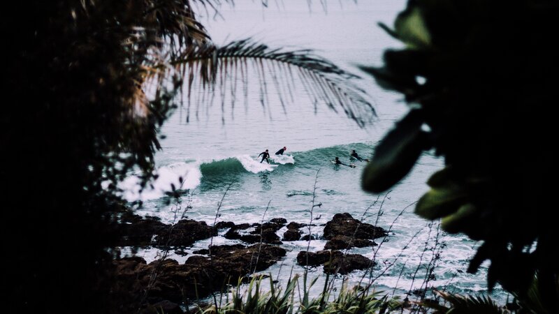 Surfers on Ocean Waves — Green, Calm