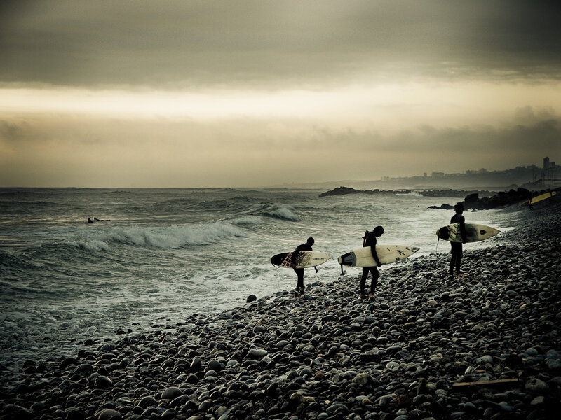 Surfers on Rocky Beach
