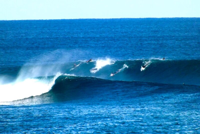 Surfers Riding Waves