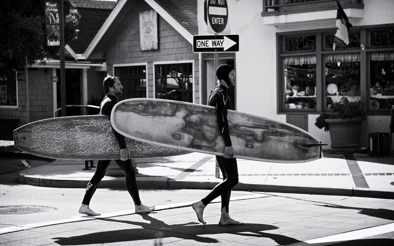 Surfers walking with boards