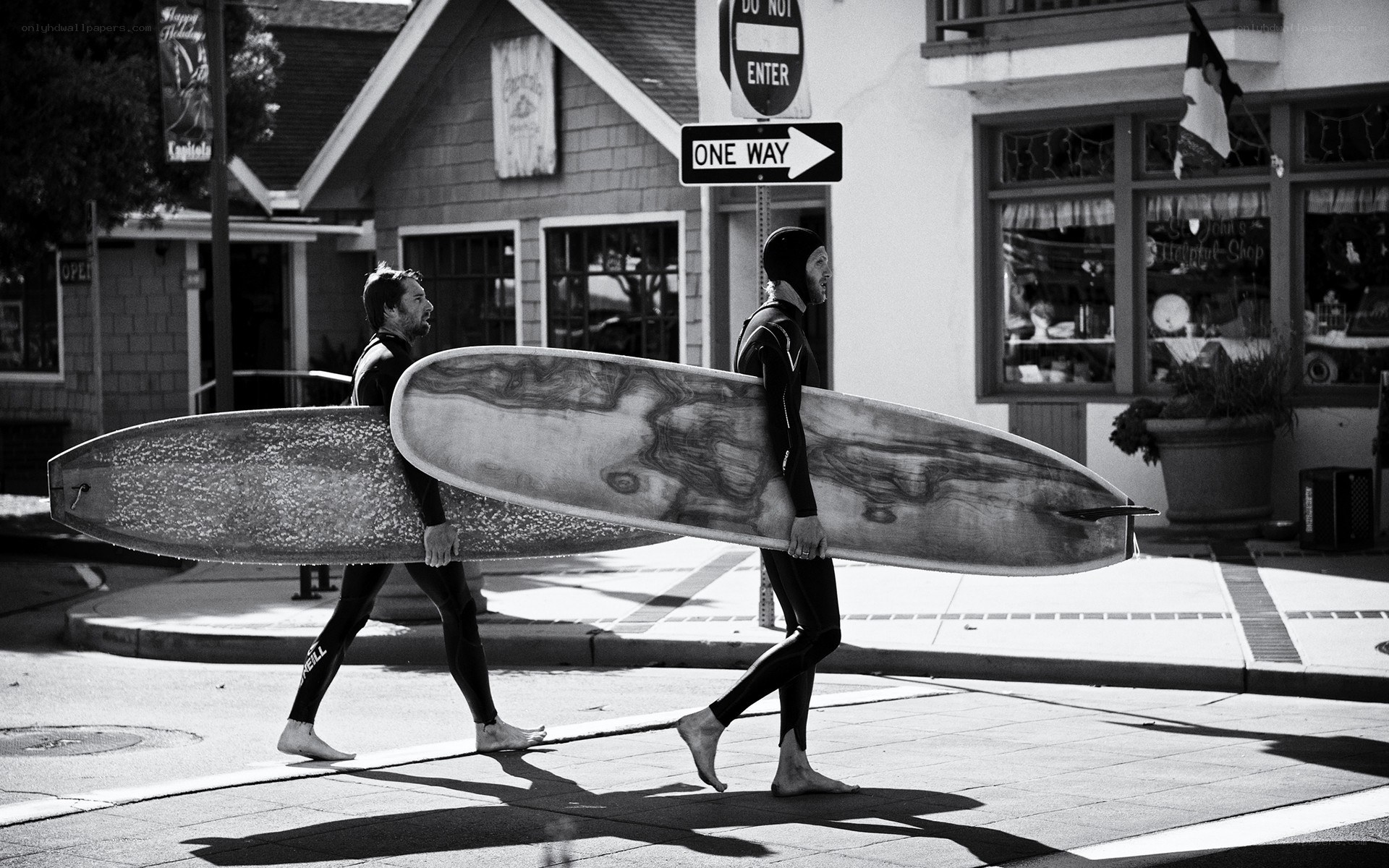 Surfers walking with boards