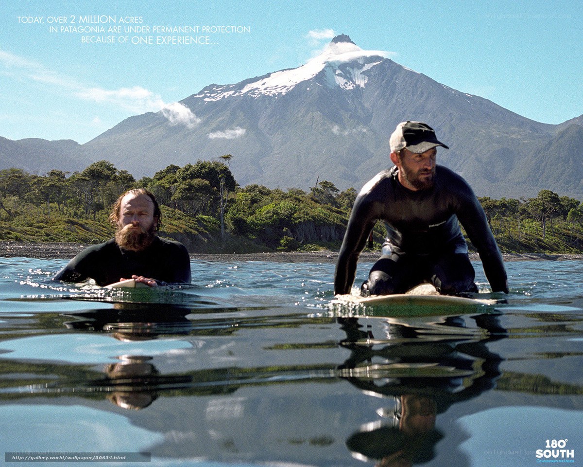 Surfers with mountain backdrop