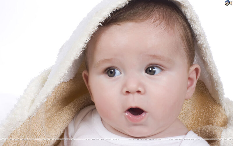 surprised baby in towel
