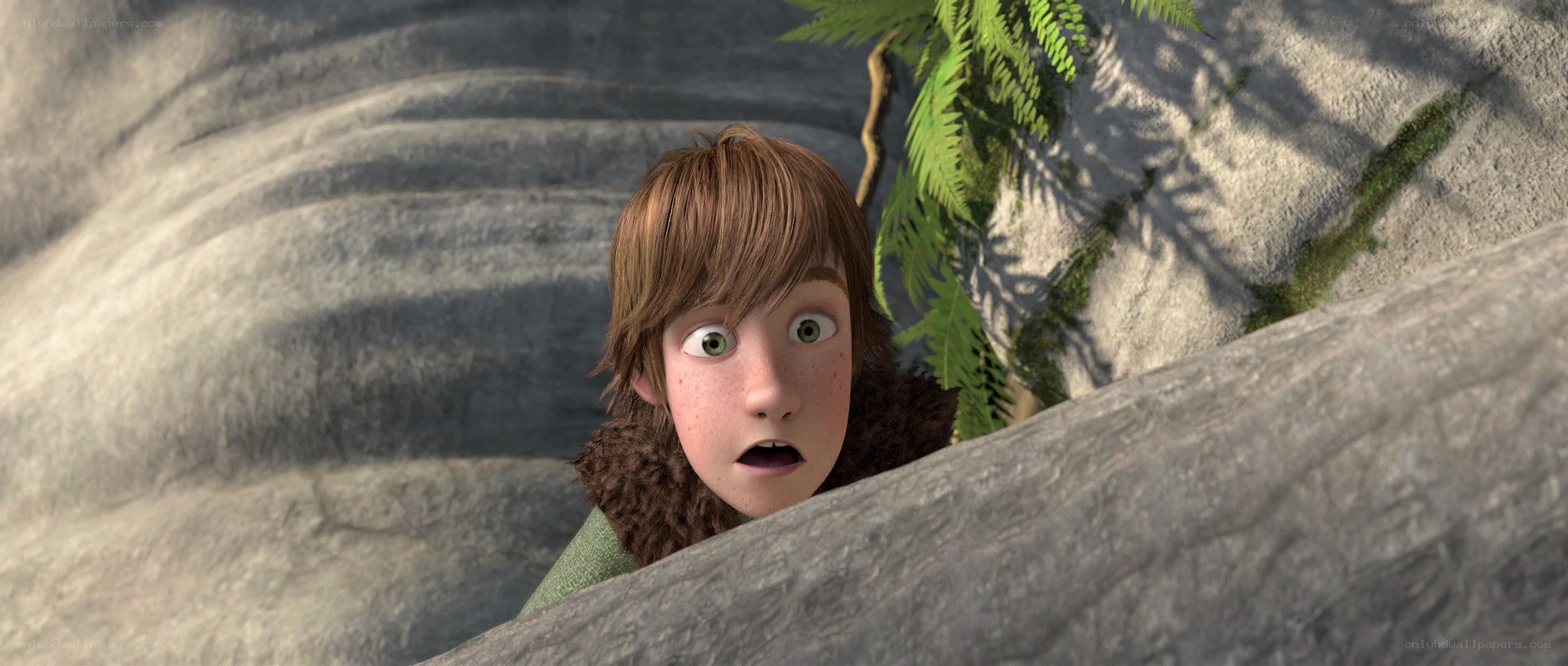 surprised boy peeking from rocks