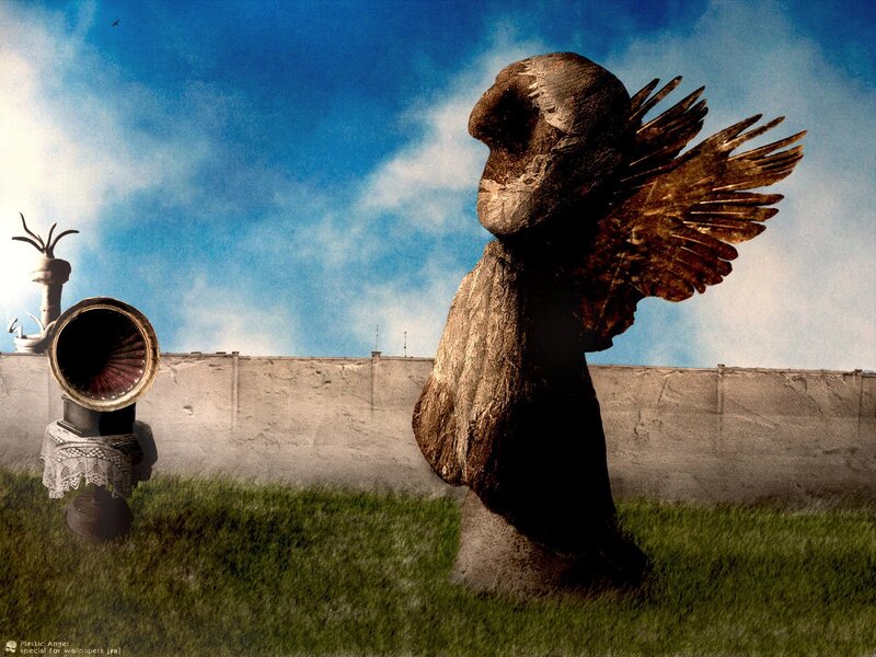 Surreal angel sculpture in field