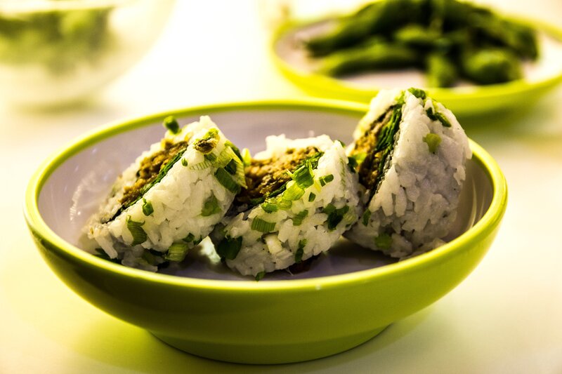 sushi rolls in a green bowl