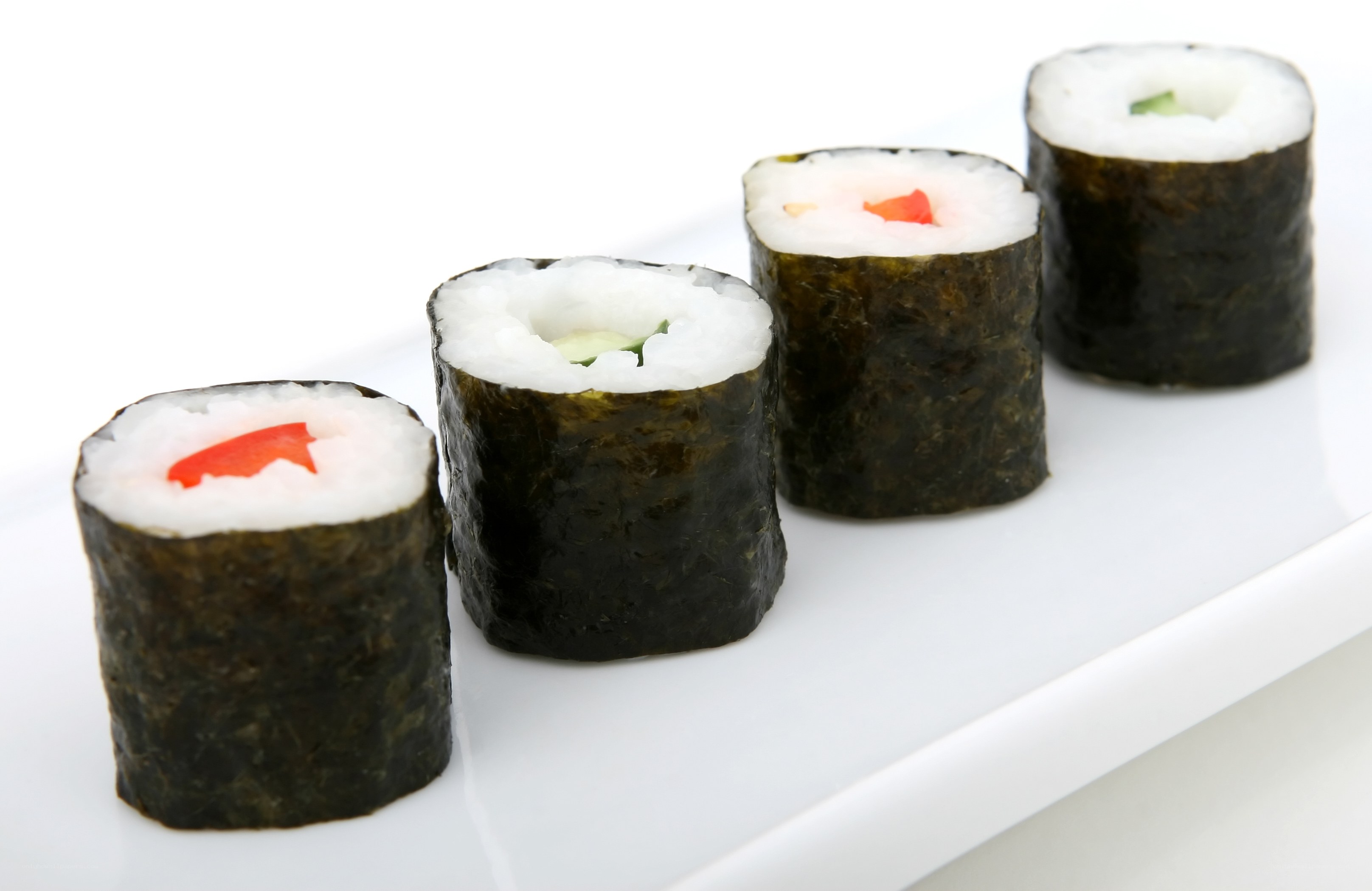 sushi rolls on a white plate