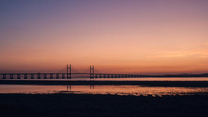 Suspension Bridge at Dusk — Orange, Serene, Sunset
