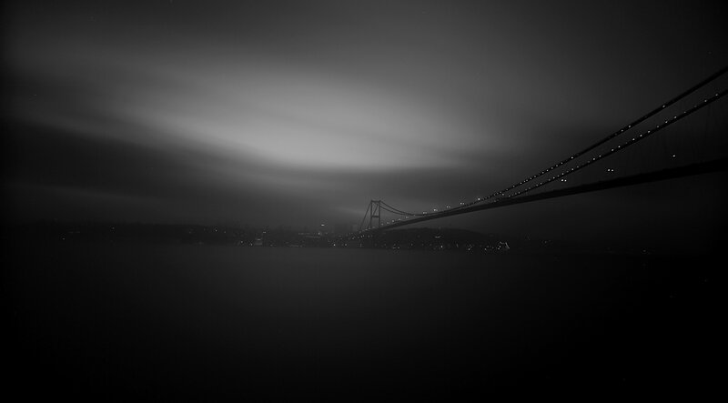 Suspension Bridge at Night — Black, Dramatic, Photograph, City Lights, Water