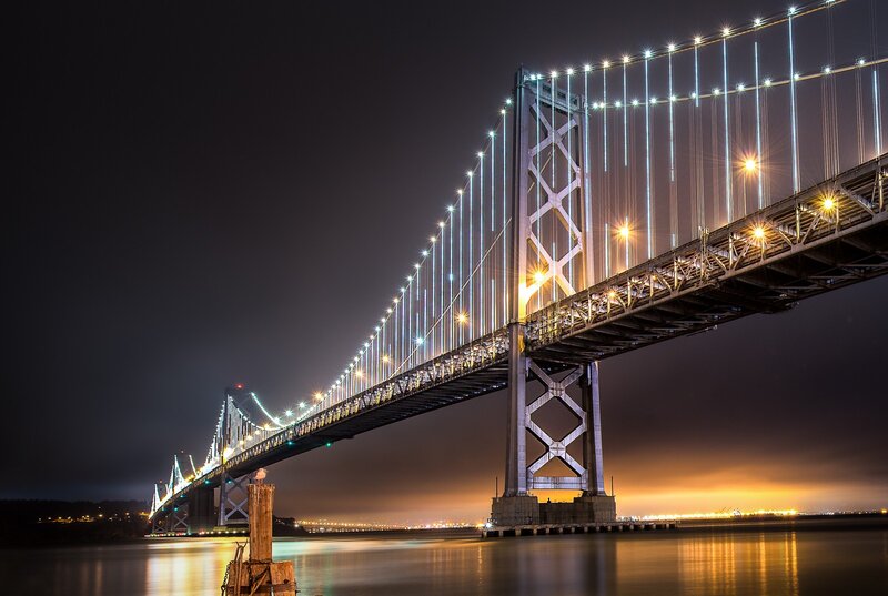 Suspension Bridge at Night — Black, Dramatic, Photograph, Lights, Water