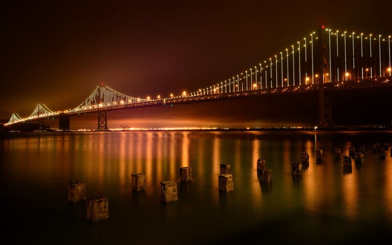 Suspension Bridge at Night — Black, Dramatic, Photograph, Water, Lights