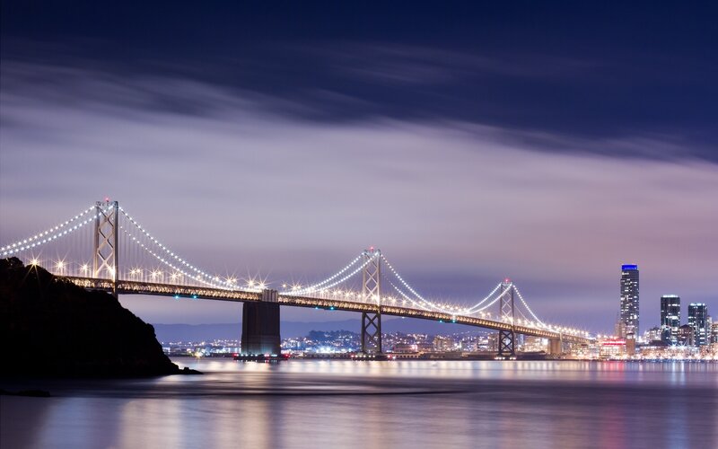 Suspension Bridge at Night — Blue, Serene, Photograph, City Skyline