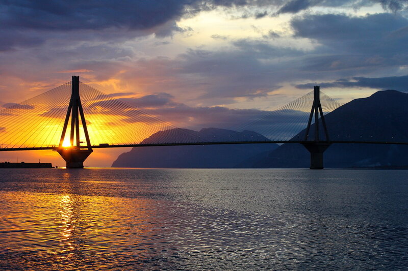Suspension Bridge at Sunset — Orange, Dramatic, Photograph, Mountains
