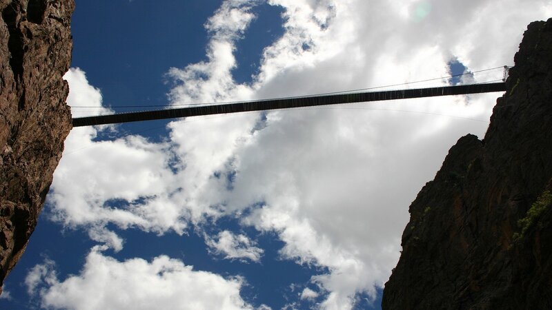 Suspension Bridge Between Cliffs — Blue, Dramatic