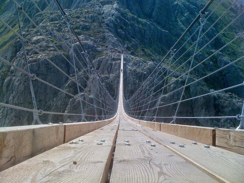 Suspension Bridge in Mountains — Brown